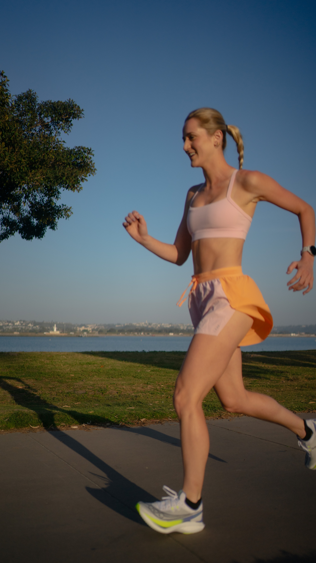 Coach running along the bay at golden hour